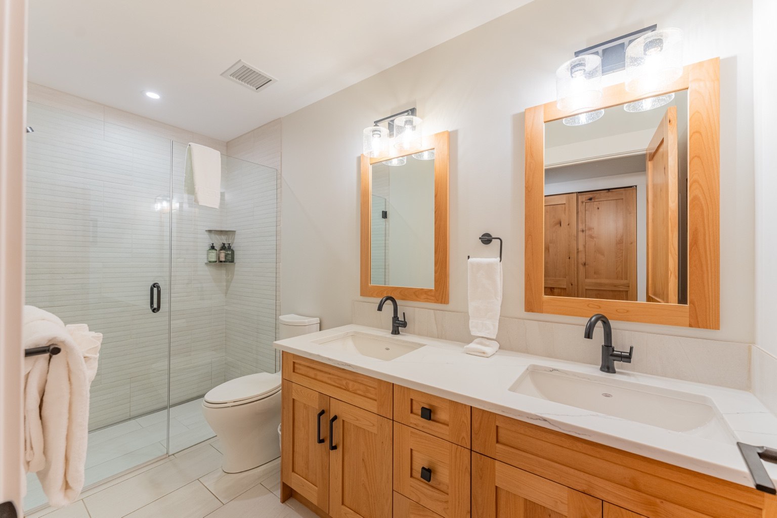Contemporary bathroom with double vanity and glass shower
