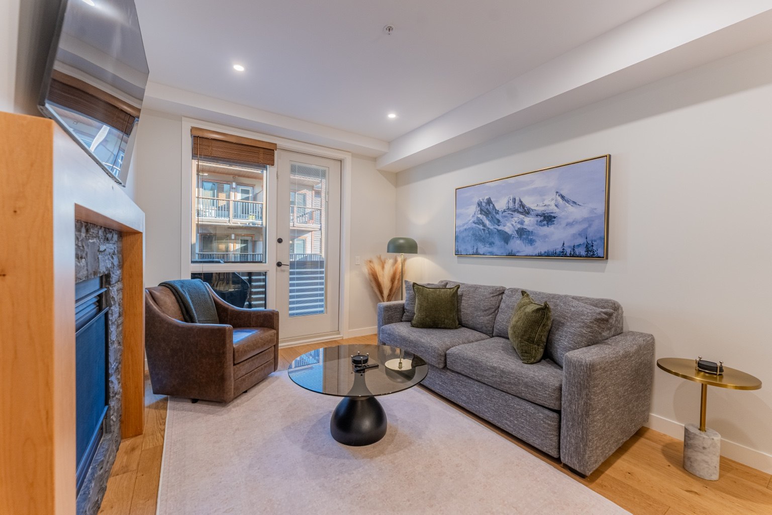 Cozy lounge with fireplace and alpine artwork
